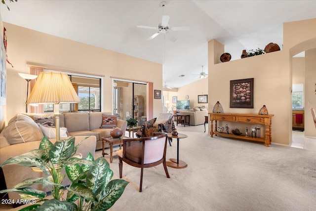 carpeted living room with high vaulted ceiling and ceiling fan