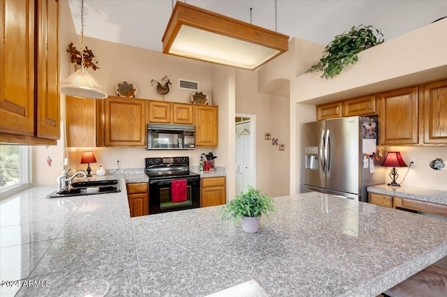 kitchen with a high ceiling, sink, kitchen peninsula, and black appliances