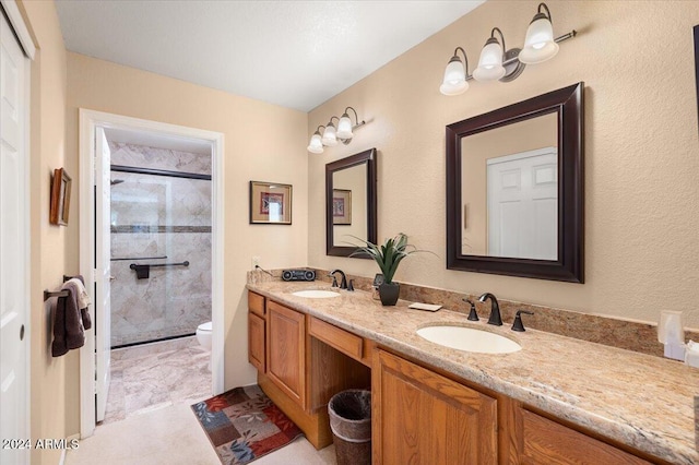 bathroom featuring toilet, walk in shower, and vanity