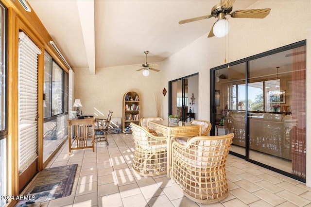 dining space with ceiling fan, light tile patterned floors, and lofted ceiling with beams