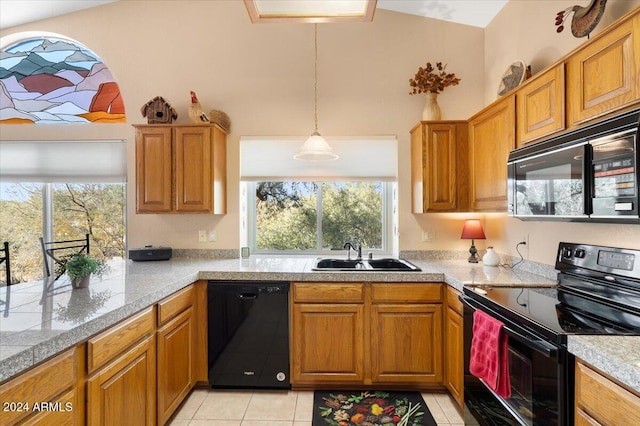 kitchen featuring black appliances, plenty of natural light, sink, and light tile patterned flooring