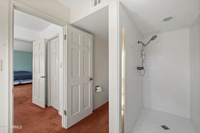 bathroom with a tile shower