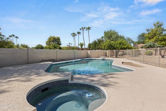 view of pool featuring an in ground hot tub and a patio area