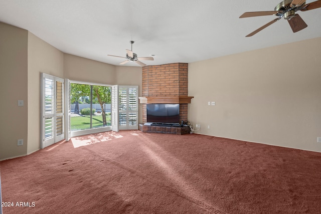 unfurnished living room featuring ceiling fan, carpet floors, and a fireplace