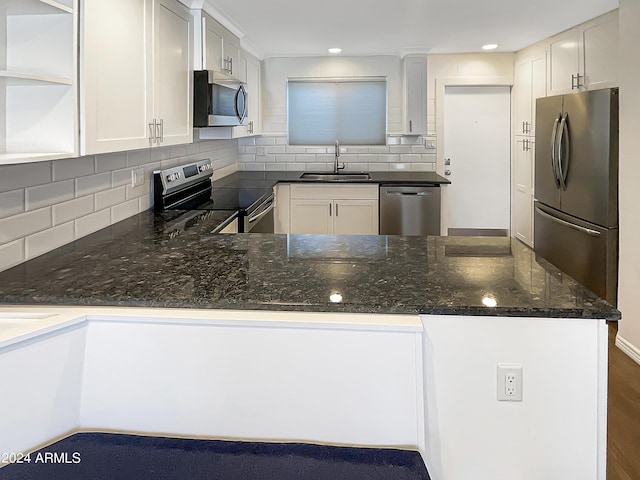 kitchen featuring stainless steel appliances, sink, white cabinets, and kitchen peninsula