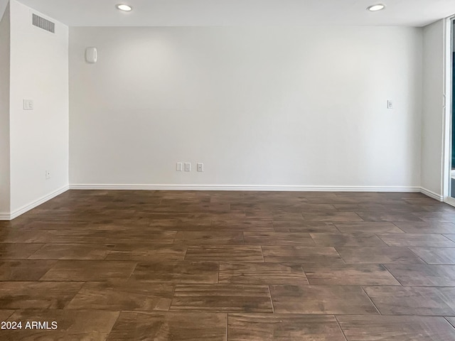 spare room with dark hardwood / wood-style floors