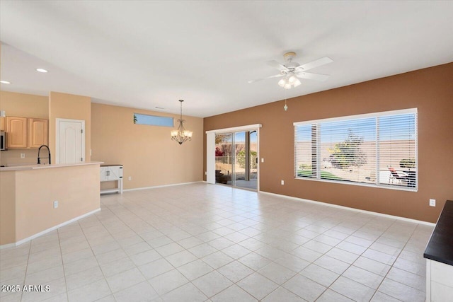 unfurnished living room featuring sink, light tile patterned floors, and ceiling fan with notable chandelier