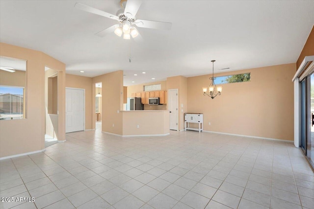 unfurnished living room featuring ceiling fan with notable chandelier and light tile patterned floors