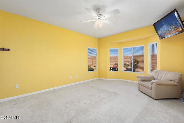 sitting room featuring ceiling fan and light carpet