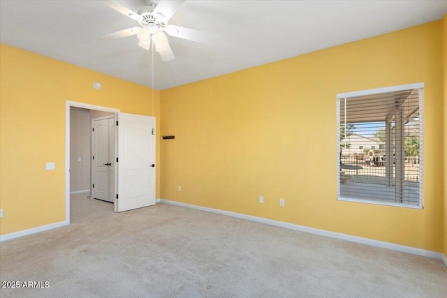 carpeted spare room with ceiling fan