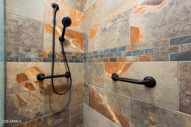 interior details with a tile shower