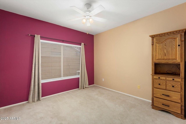 unfurnished room with light carpet and ceiling fan