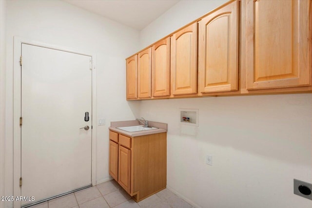 washroom with hookup for an electric dryer, washer hookup, cabinets, sink, and light tile patterned flooring