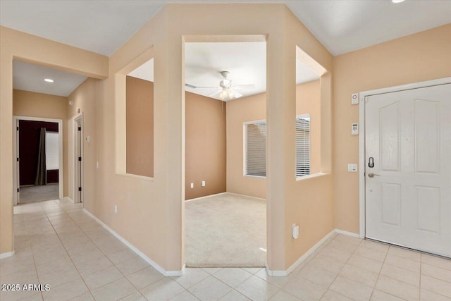 carpeted foyer featuring ceiling fan