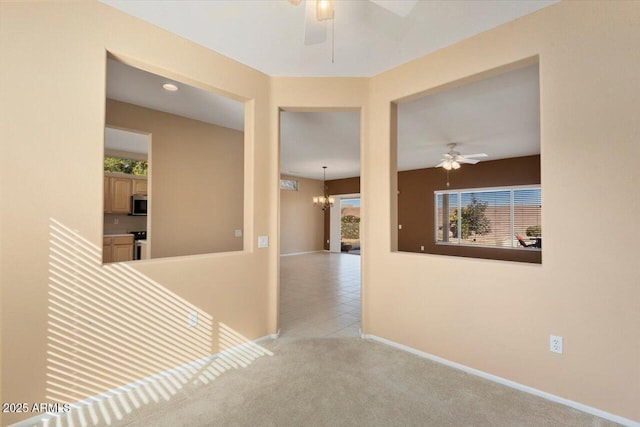 hall with a chandelier and light colored carpet