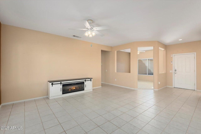 unfurnished living room with ceiling fan and light tile patterned floors