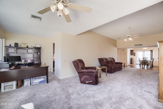 home office with ceiling fan, light carpet, and a textured ceiling