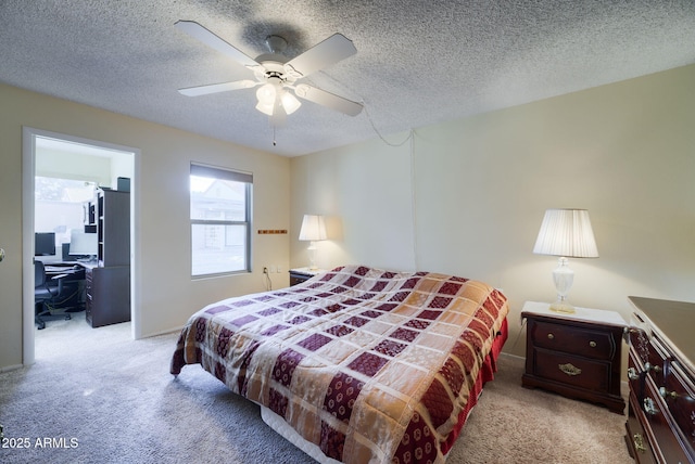 bedroom featuring ceiling fan, light carpet, and a textured ceiling