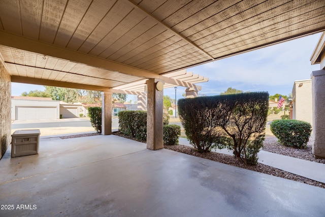 view of patio featuring a garage and a pergola