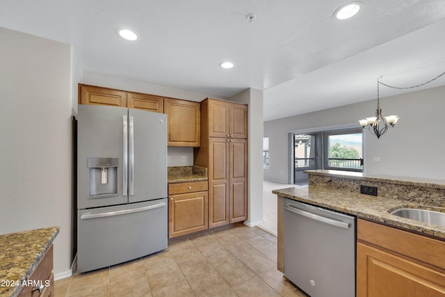 kitchen with a chandelier, appliances with stainless steel finishes, light tile patterned floors, decorative light fixtures, and light stone countertops