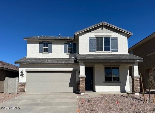 view of front facade featuring a porch, driveway, an attached garage, and stucco siding