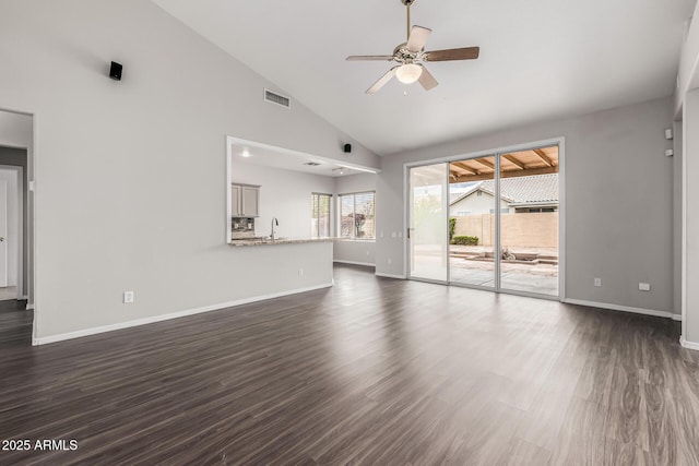 unfurnished living room featuring dark wood finished floors, visible vents, a ceiling fan, and baseboards