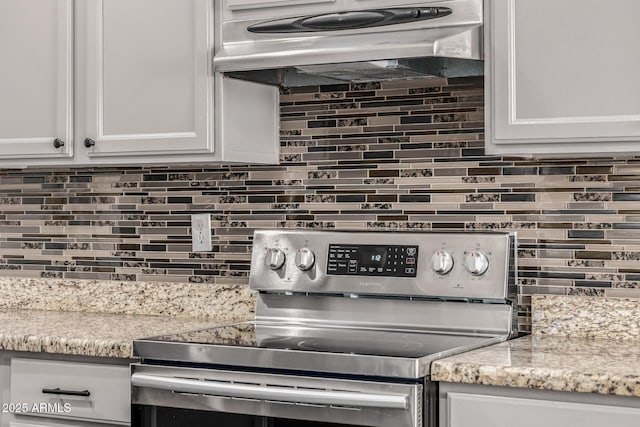 kitchen with white cabinetry, backsplash, exhaust hood, and stainless steel range with electric cooktop