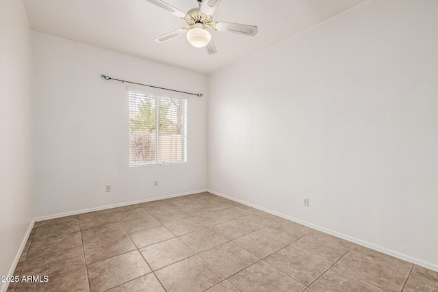 unfurnished room with light tile patterned flooring, baseboards, and a ceiling fan