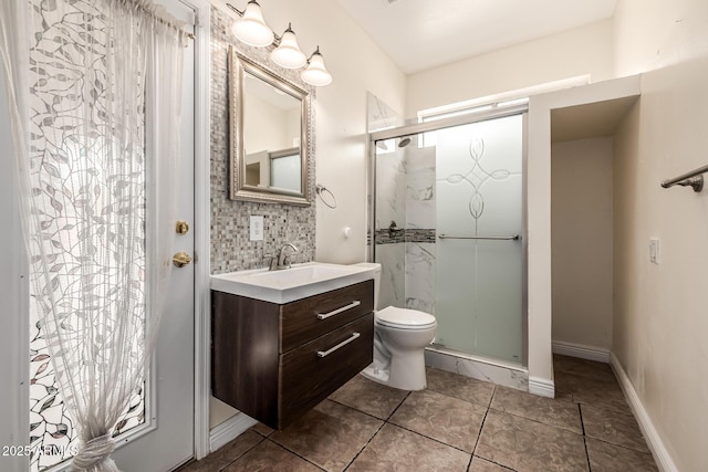 bathroom with vanity, baseboards, decorative backsplash, a shower stall, and toilet