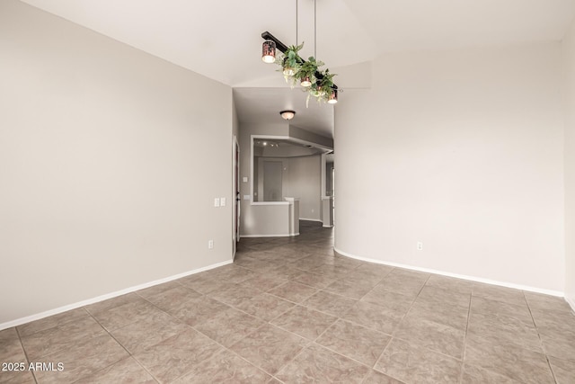 interior space with baseboards and lofted ceiling