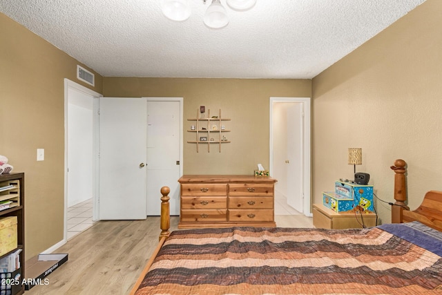 1951 E Del Sur Dr, Tempe, AZ 85283 - bedroom with light wood-type flooring and a textured ceiling