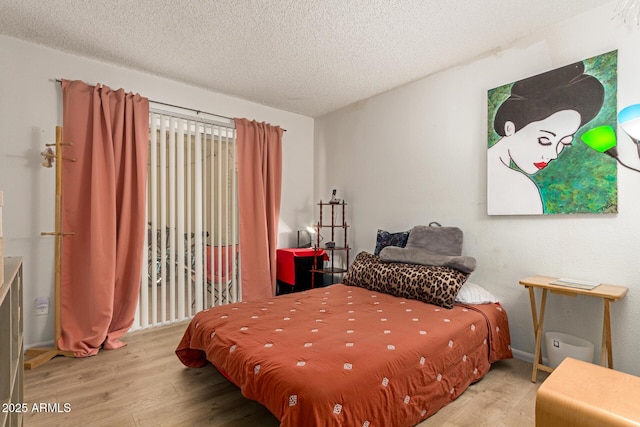 1951 E Del Sur Dr, Tempe, AZ 85283 - bedroom featuring wood finished floors and a textured ceiling
