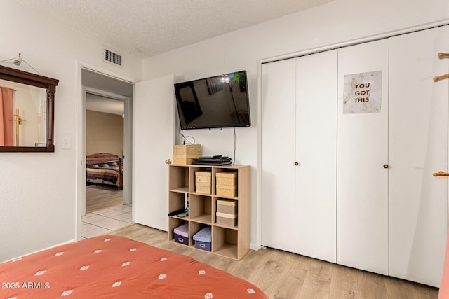 1951 E Del Sur Dr, Tempe, AZ 85283 - bedroom featuring wood finished floors, a closet, and a textured ceiling
