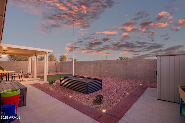 view of patio terrace at dusk