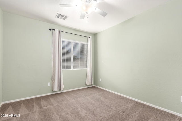 carpeted spare room featuring ceiling fan