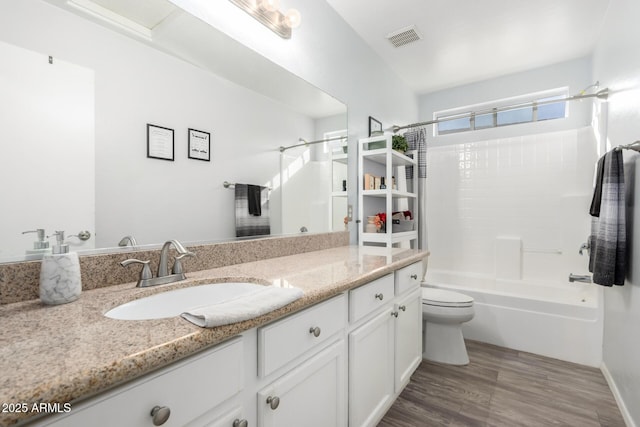 full bathroom with vanity, toilet, shower / washtub combination, and hardwood / wood-style floors