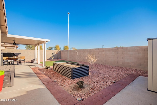 view of yard featuring ceiling fan and a patio area