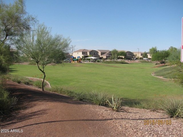 view of home's community with a playground and a lawn