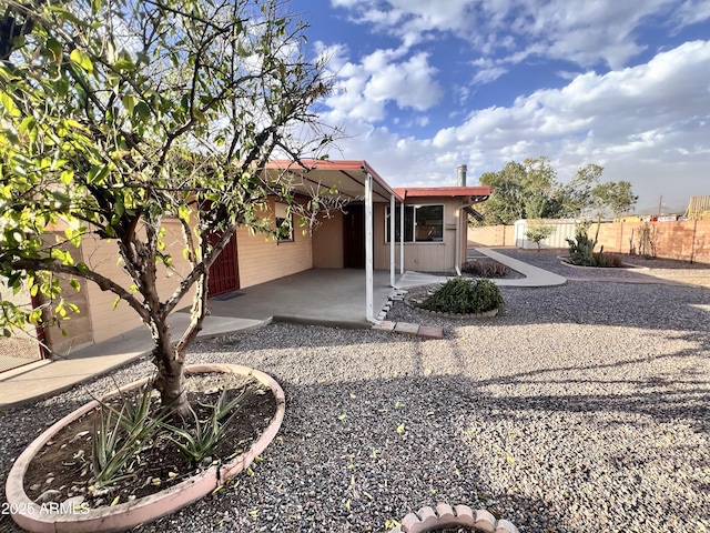 exterior space featuring a patio area and fence