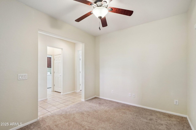 spare room featuring light carpet and washer / dryer