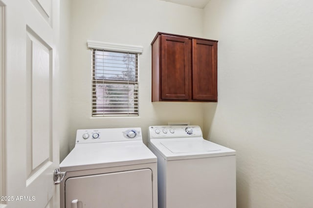 washroom with cabinets and washing machine and dryer