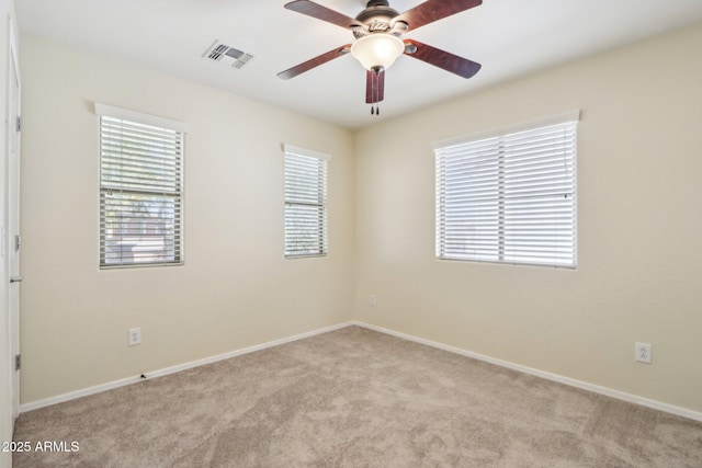 carpeted empty room featuring ceiling fan