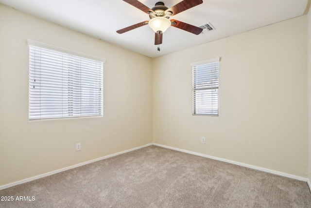 carpeted spare room with ceiling fan