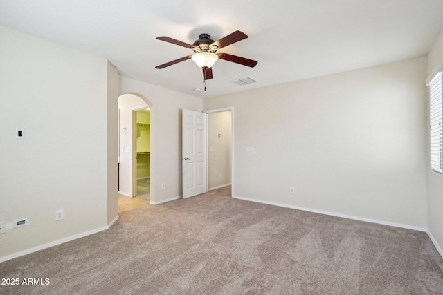 carpeted spare room featuring ceiling fan