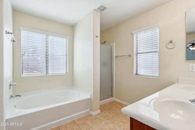 bathroom featuring vanity, a wealth of natural light, and separate shower and tub