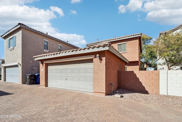 view of side of home featuring a garage