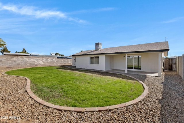 back of property featuring a yard, cooling unit, and a patio area