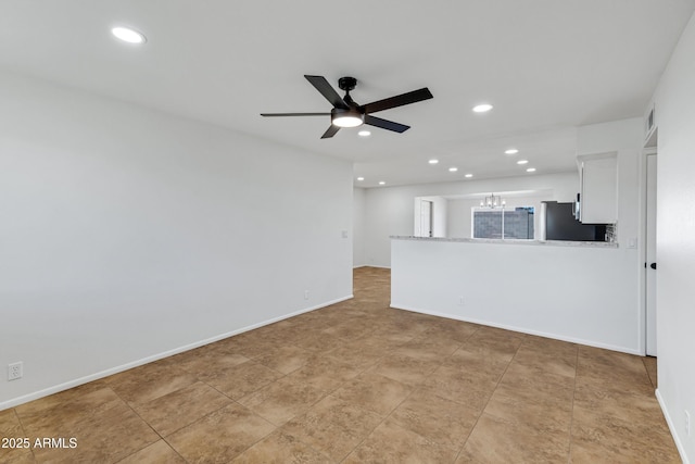 interior space featuring ceiling fan with notable chandelier