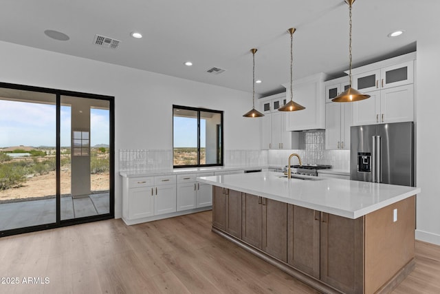 34198 S State Route 89th Hwy, Wickenburg, AZ 85390 - kitchen with high end fridge, light wood-style flooring, light countertops, white cabinets, and recessed lighting