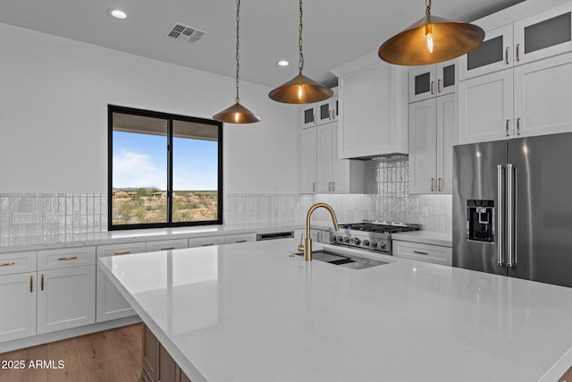 34198 S State Route 89th Hwy, Wickenburg, AZ 85390 - kitchen with high quality fridge, recessed lighting, a sink, an island with sink, and backsplash